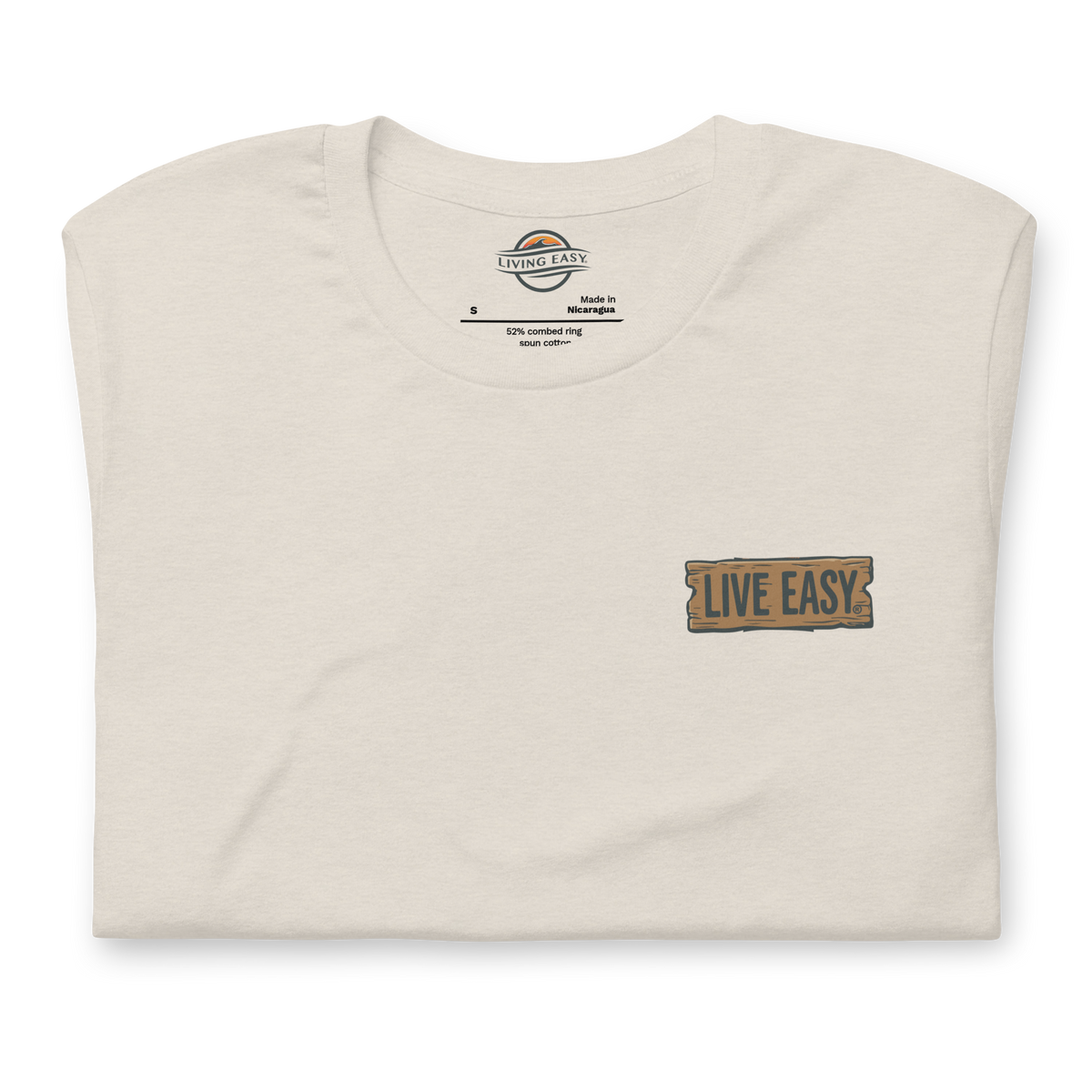 Folded beige t-shirt with 'Live Easy' patch on a white background